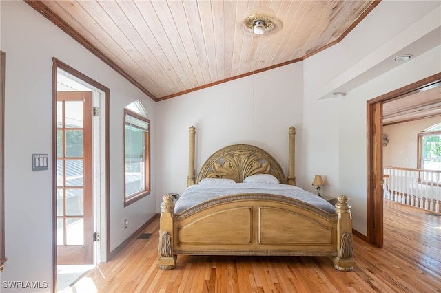 bedroom featuring light hardwood / wood-style floors, crown molding, and wood ceiling