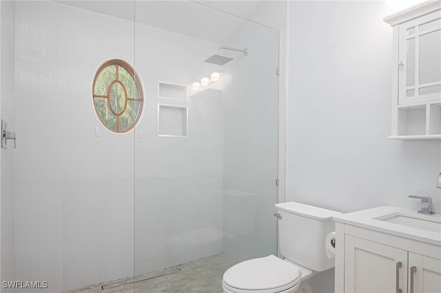 bathroom featuring vanity, toilet, and walk in shower