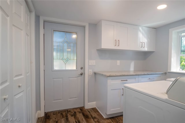 washroom featuring washer and dryer, cabinets, and dark wood-type flooring