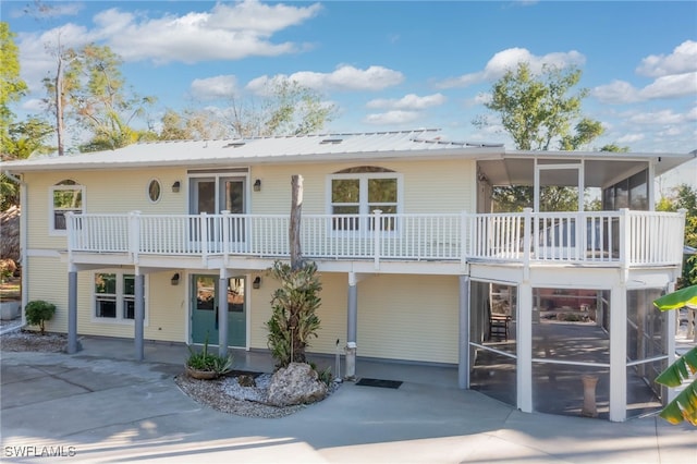 back of property with a sunroom