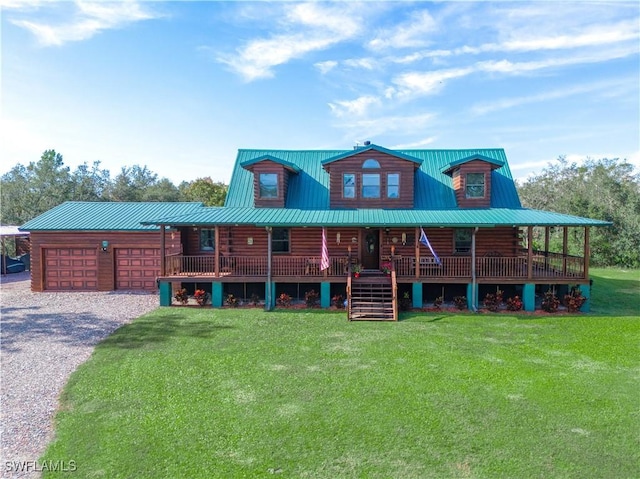 cabin featuring a garage, covered porch, and a front yard