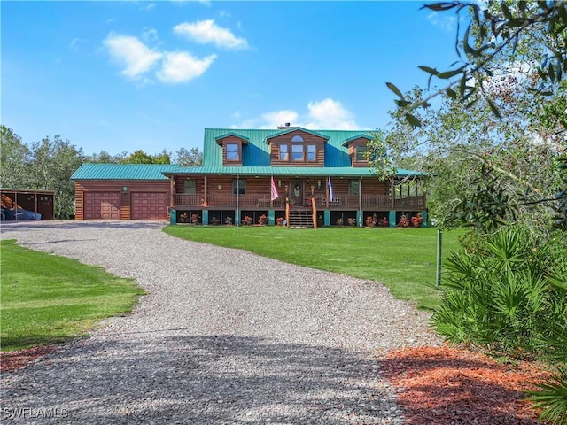 log-style house with a porch, a garage, and a front lawn