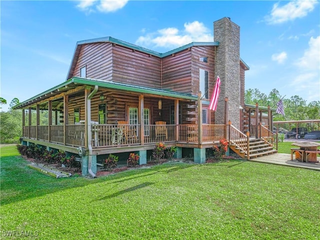 rear view of house featuring a lawn