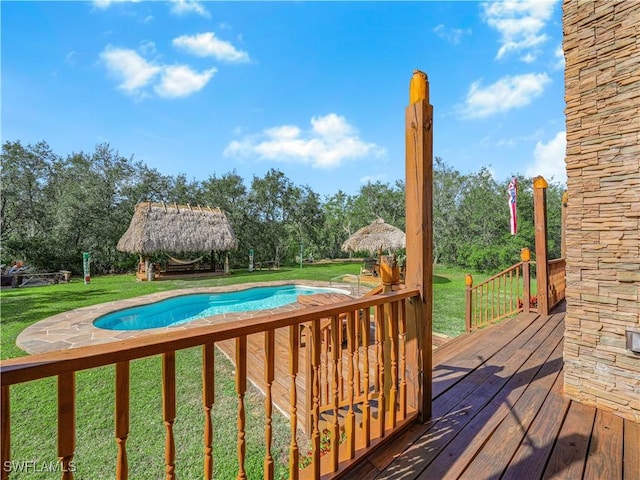 view of pool featuring a gazebo, a wooden deck, and a lawn