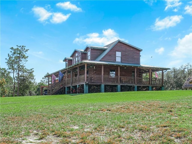 rear view of property with a lawn