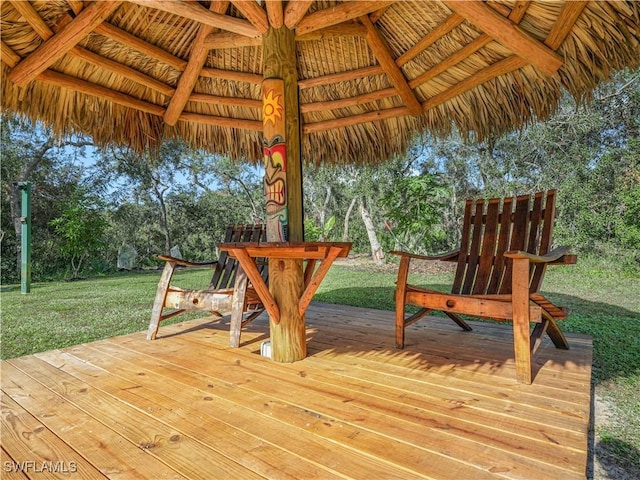 wooden terrace featuring a gazebo and a lawn