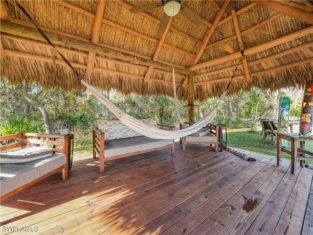 wooden terrace featuring a gazebo and ceiling fan