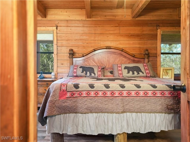 bedroom featuring wood walls, beam ceiling, wooden ceiling, and multiple windows