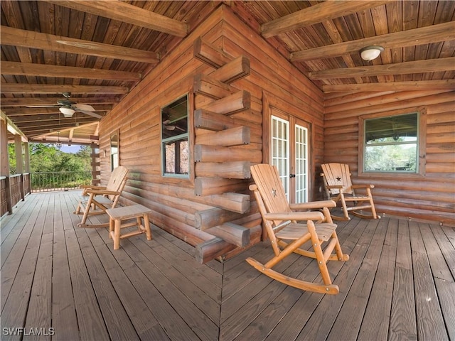 wooden deck featuring covered porch and ceiling fan