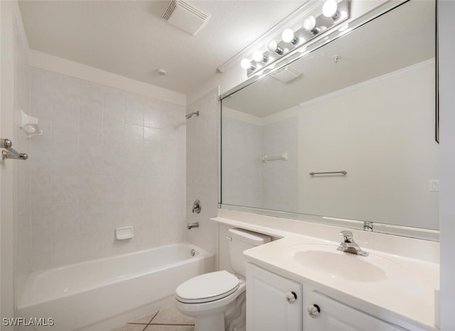 full bathroom with vanity, tile patterned floors, tiled shower / bath, toilet, and a textured ceiling