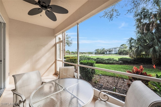 sunroom featuring ceiling fan