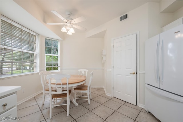 dining room with light tile patterned floors and ceiling fan