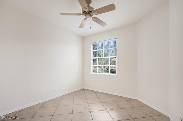 empty room featuring ceiling fan and light tile patterned floors