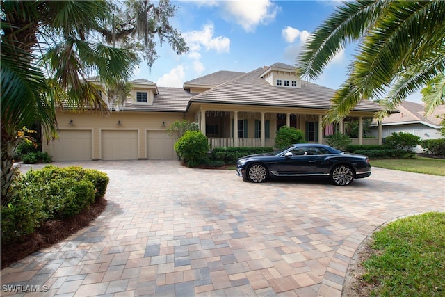 view of front of house with a porch and a garage