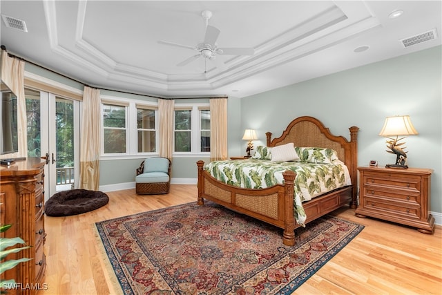 bedroom with multiple windows, access to exterior, light hardwood / wood-style floors, and ceiling fan