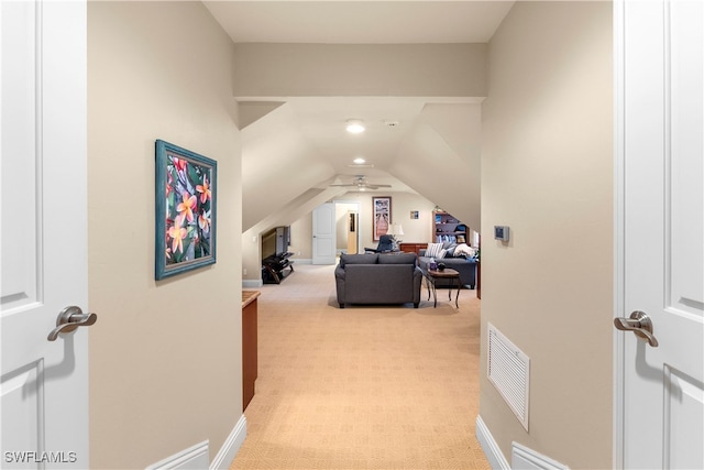 interior space featuring light carpet and lofted ceiling