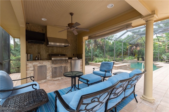 view of patio featuring a grill, ceiling fan, exterior kitchen, and glass enclosure