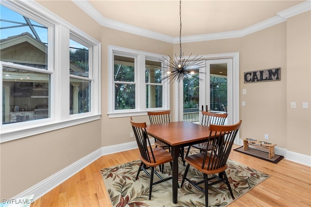 12261 Hammock Creek Way, Fort Myers, FL 33905 - dining room with a chandelier, plenty of natural light, light wood-style floors, and crown molding