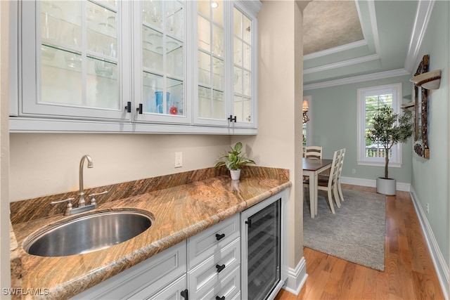 12261 Hammock Creek Way, Fort Myers, FL 33905 - indoor wet bar with beverage cooler, light wood-type flooring, crown molding, and a raised ceiling