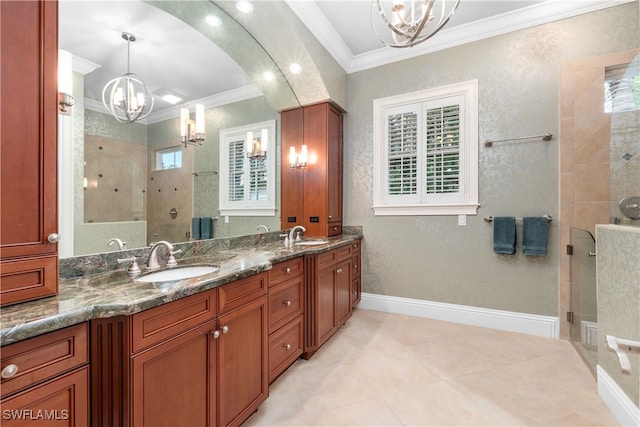 bathroom featuring plenty of natural light, a chandelier, tiled shower, vanity, and ornamental molding