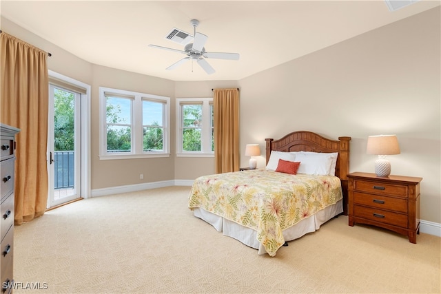 bedroom featuring access to exterior, light colored carpet, and ceiling fan