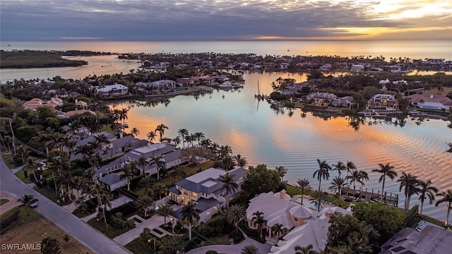 aerial view at dusk with a water view