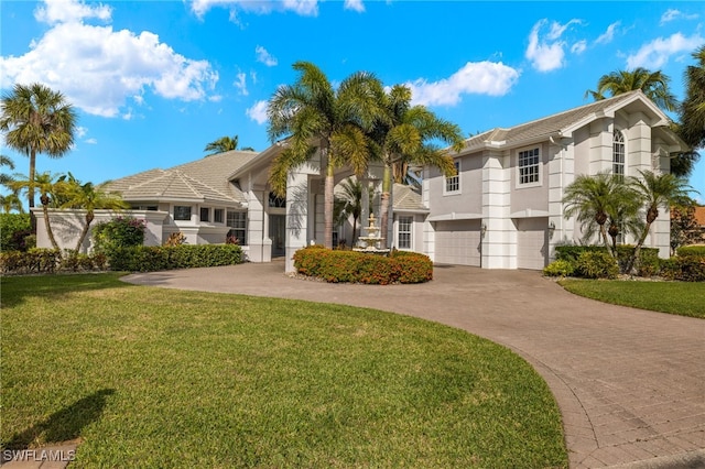 view of front of home featuring a garage and a front lawn