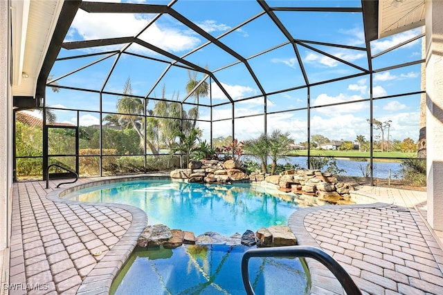 view of swimming pool with a patio, a water view, and glass enclosure