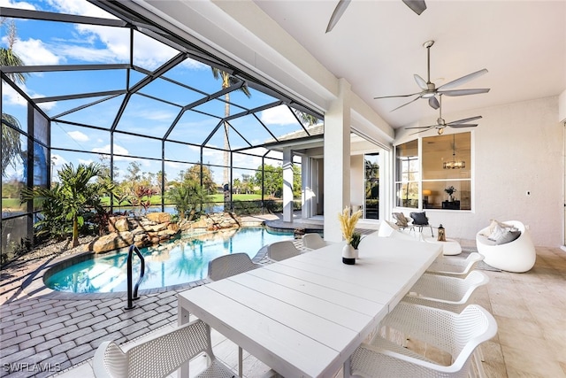 view of pool with a lanai, ceiling fan, and a patio