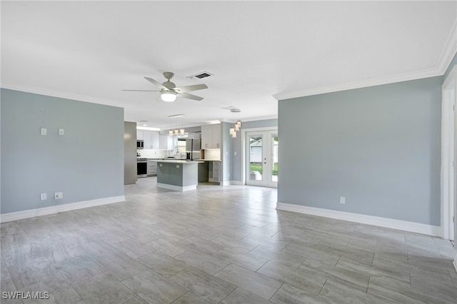 unfurnished living room with crown molding, french doors, and ceiling fan