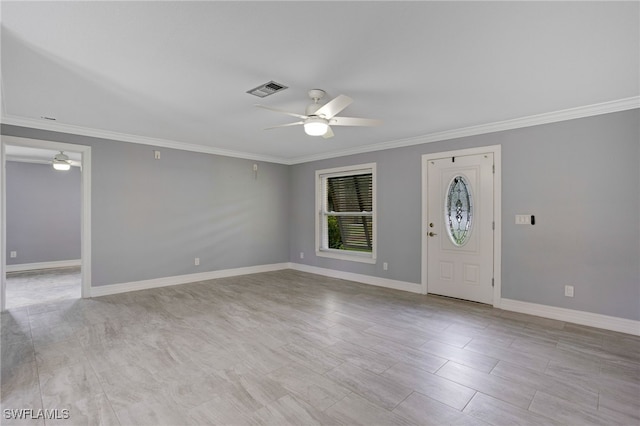 foyer entrance featuring ceiling fan and crown molding