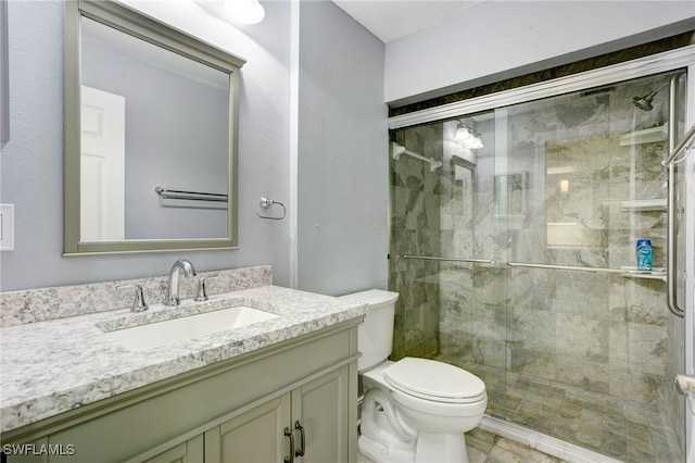 bathroom with vanity, toilet, and walk in shower