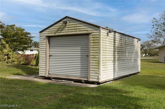 view of outbuilding with a yard