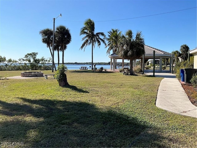 view of community with a gazebo, a water view, and a lawn