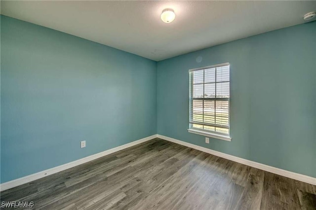 empty room with dark wood-type flooring