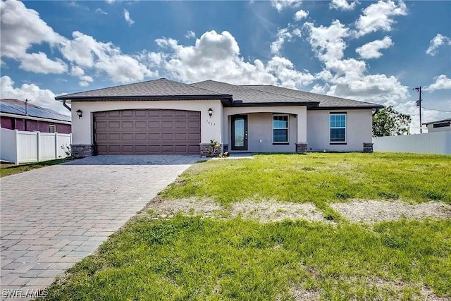 view of front of house with a garage and a front lawn