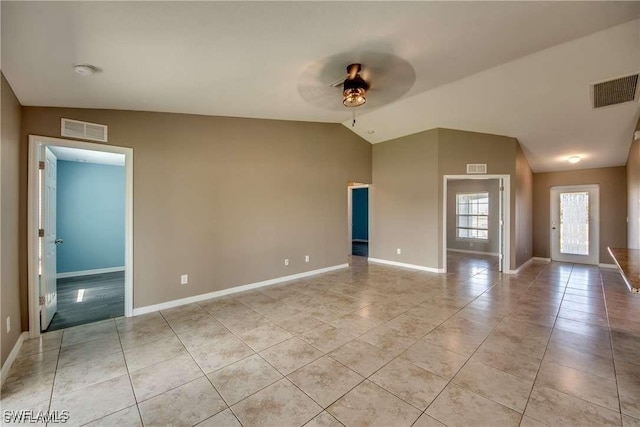 spare room featuring ceiling fan, light tile patterned flooring, and lofted ceiling