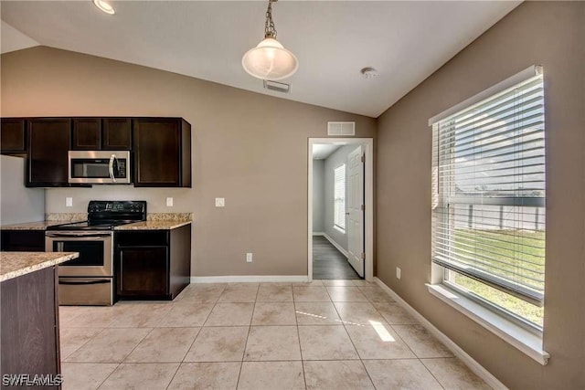 kitchen with appliances with stainless steel finishes, dark brown cabinets, plenty of natural light, and pendant lighting