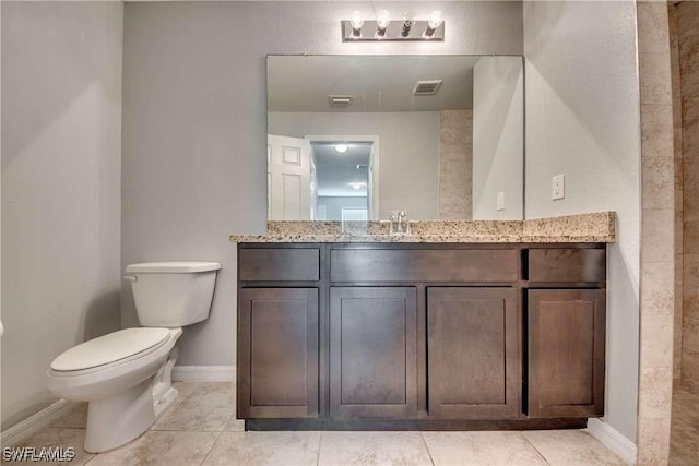 bathroom featuring tile patterned floors, vanity, and toilet