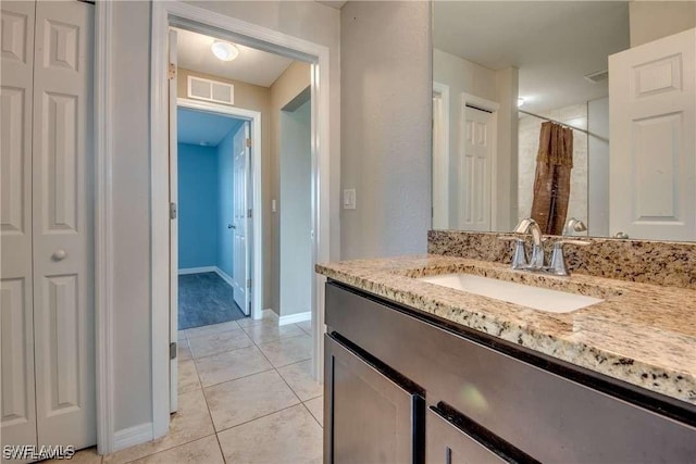 bathroom with vanity, tile patterned floors, and walk in shower