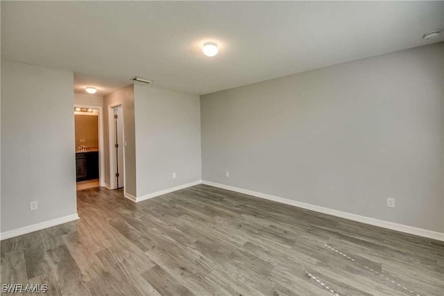 spare room with hardwood / wood-style flooring