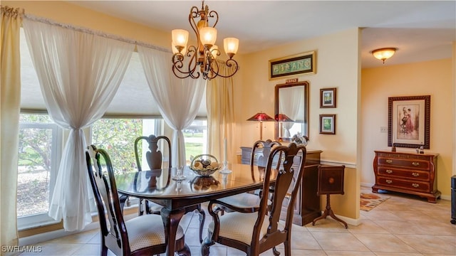 dining room featuring light tile patterned flooring and a notable chandelier