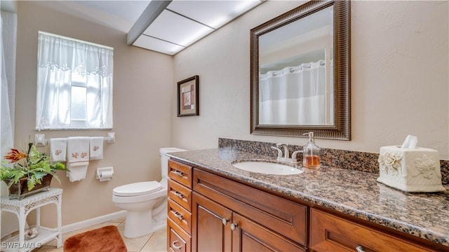 bathroom featuring vanity, tile patterned floors, and toilet