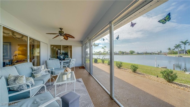 sunroom / solarium featuring a water view and ceiling fan