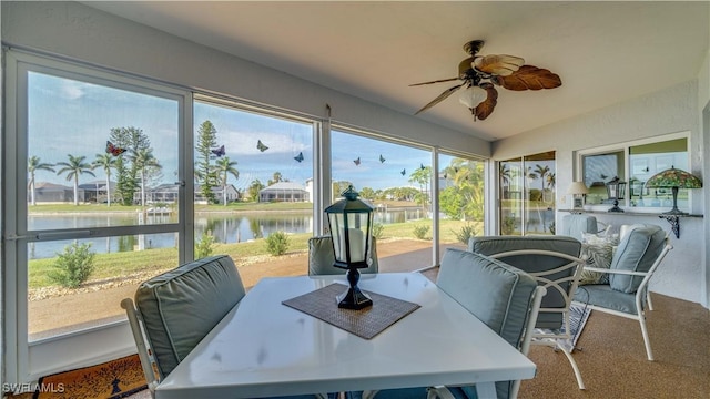 sunroom / solarium with a water view and ceiling fan