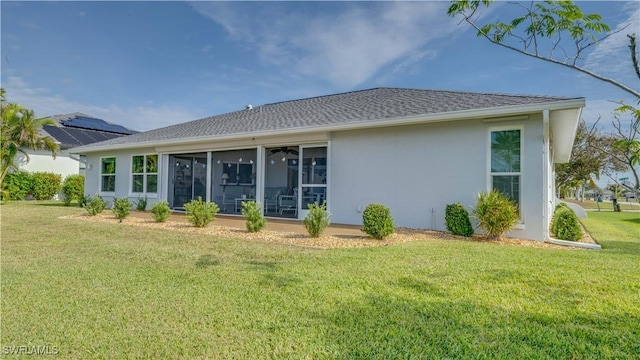 rear view of property featuring a lawn