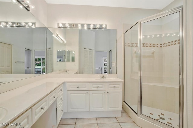 bathroom featuring walk in shower, vanity, and tile patterned flooring