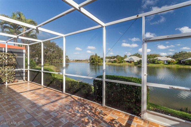 unfurnished sunroom featuring a water view