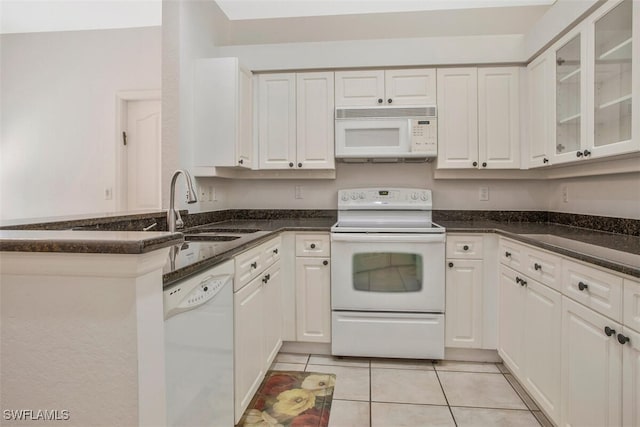 kitchen featuring light tile patterned flooring, sink, white cabinets, and white appliances