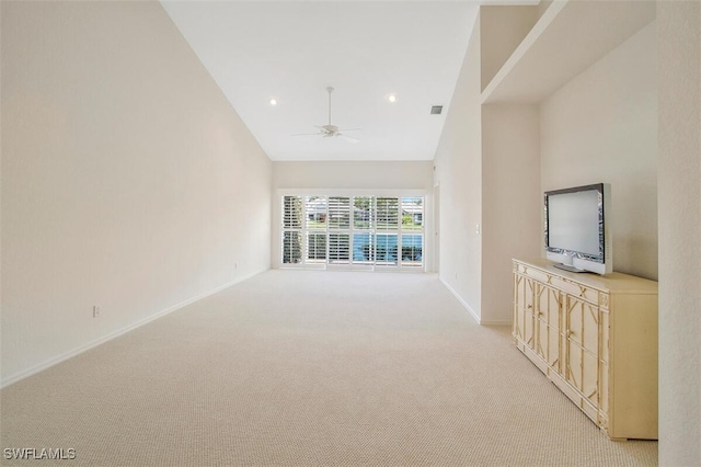 unfurnished living room with light carpet, high vaulted ceiling, and ceiling fan